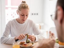close-up-of-a-woman-sitting-at-a-table-looking-dow-2026-01-11-08-58-08-utc
