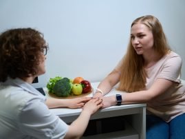 Young woman in a fitness clinic on a consultation with a nutritionist, a specialist supports a client